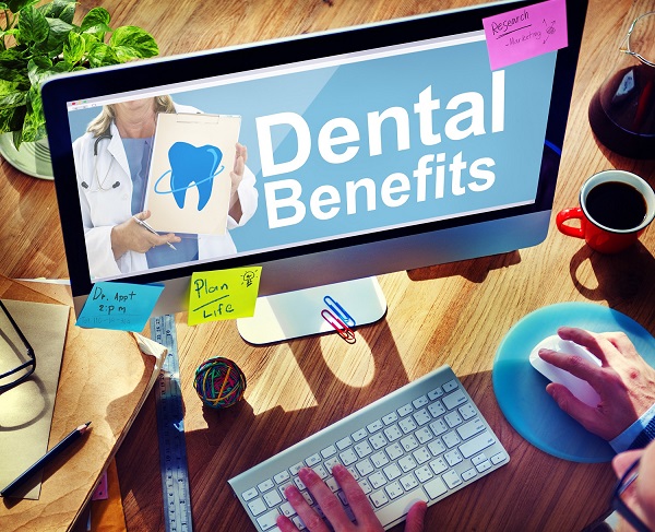 Person using a computer screen that says "dental benefits" on it