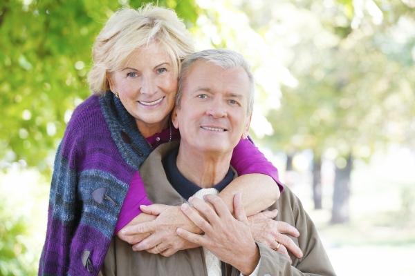 A Greece couple flashes their implant supported dentures