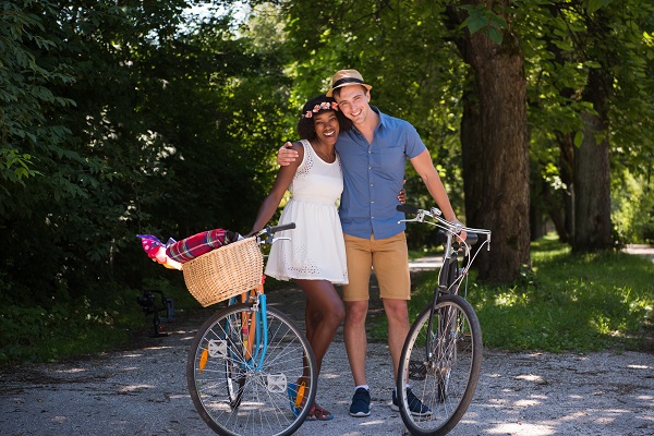 Couple biking during the Rochester summer after porcelain veneers