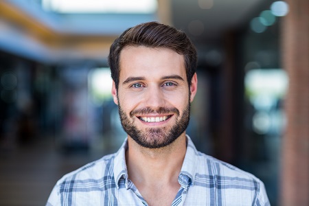 Greece NY man smiling after receiving dental crown 