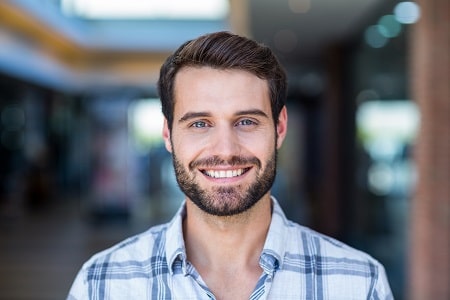 Greece NY man smiling after receiving dental crown